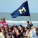 A young Michigan fan gets a better view as he sits near a block M flag while the marching band performs for fans during beach day in Clearwater, Fla. on Sunday, Dec. 30. Melanie Maxwell I AnnArbor.com
